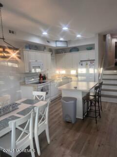 433 West Avenue, Unit 1 Ocean City, NJ 08226 - Photo 6 of 29 a kitchen with kitchen island a sink stove and white cabinets