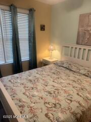 433 West Avenue, Unit 1 Ocean City, NJ 08226 - Photo 8 of 29 a bedroom with a bed and a window