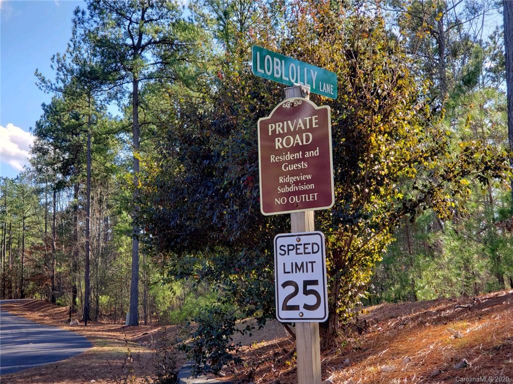 0 Loblolly Ln Mill Spring, Unit 23 & 24 Mill Spring, NC 28756 - Photo 17 of 18 a sign on a pole on a street