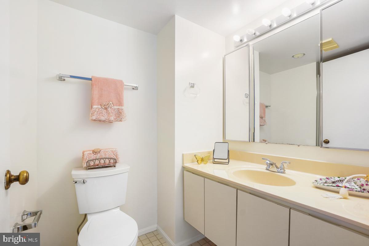 15107 Interlachen Drive, Unit 2321 Silver Spring, MD 20906 - Photo 30 of 35 a bathroom with a toilet sink and mirror
