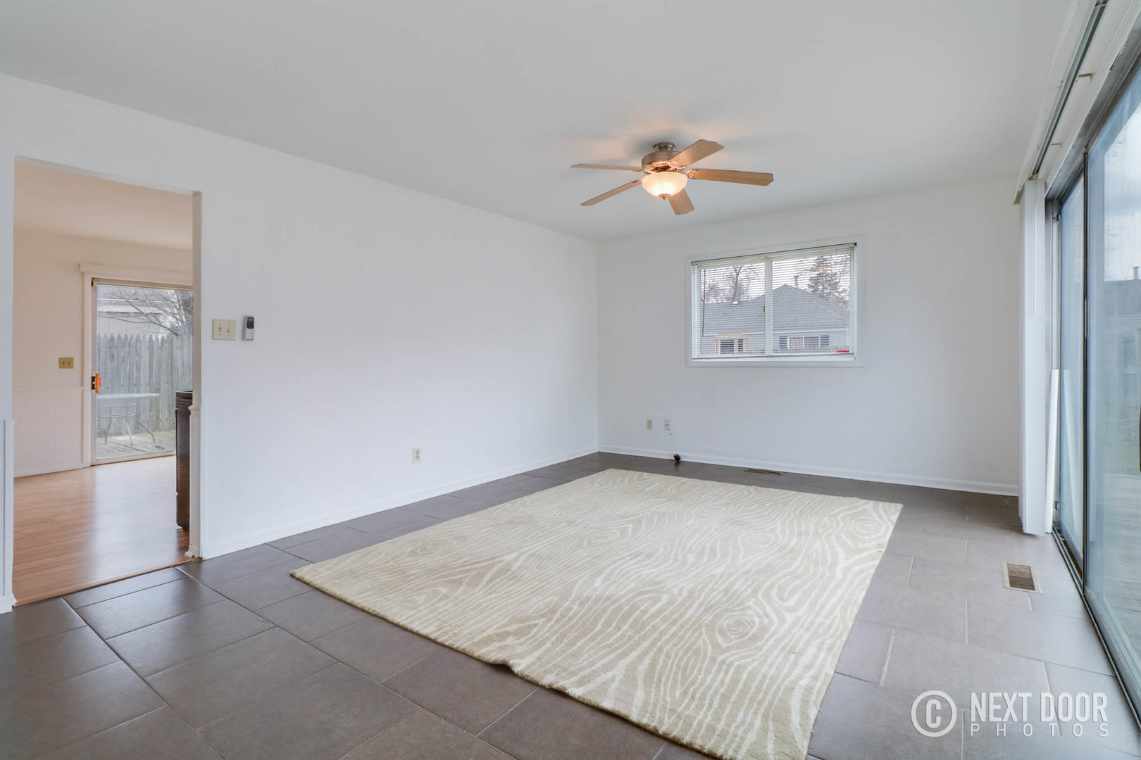 159 Heathgate Road Montgomery, IL 60538 - Photo 14 of 21 an empty room with a chandelier fan and kitchen view