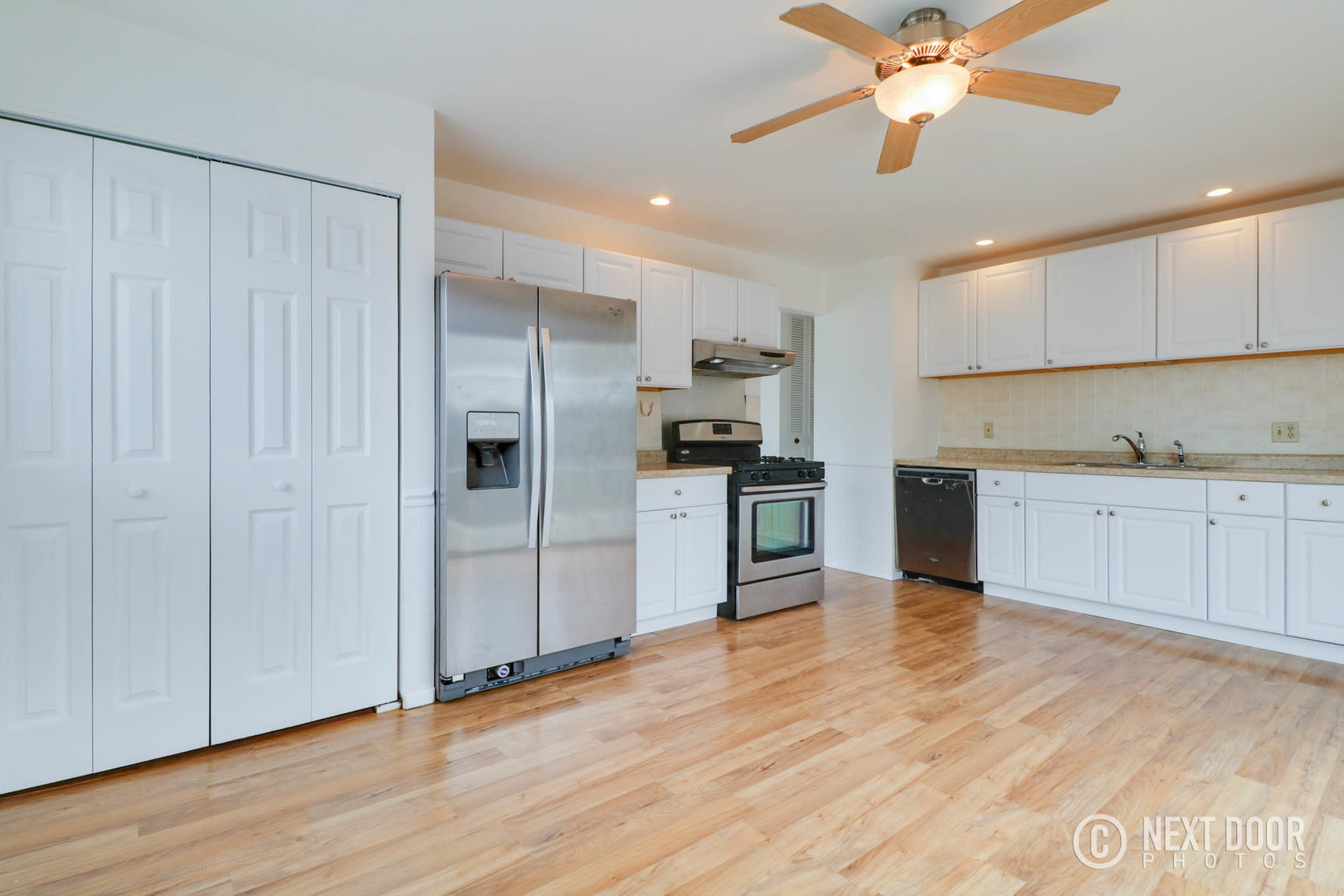 159 Heathgate Road Montgomery, IL 60538 - Photo 3 of 21 a kitchen with stainless steel appliances kitchen island granite countertop a refrigerator a sink and white cabinets