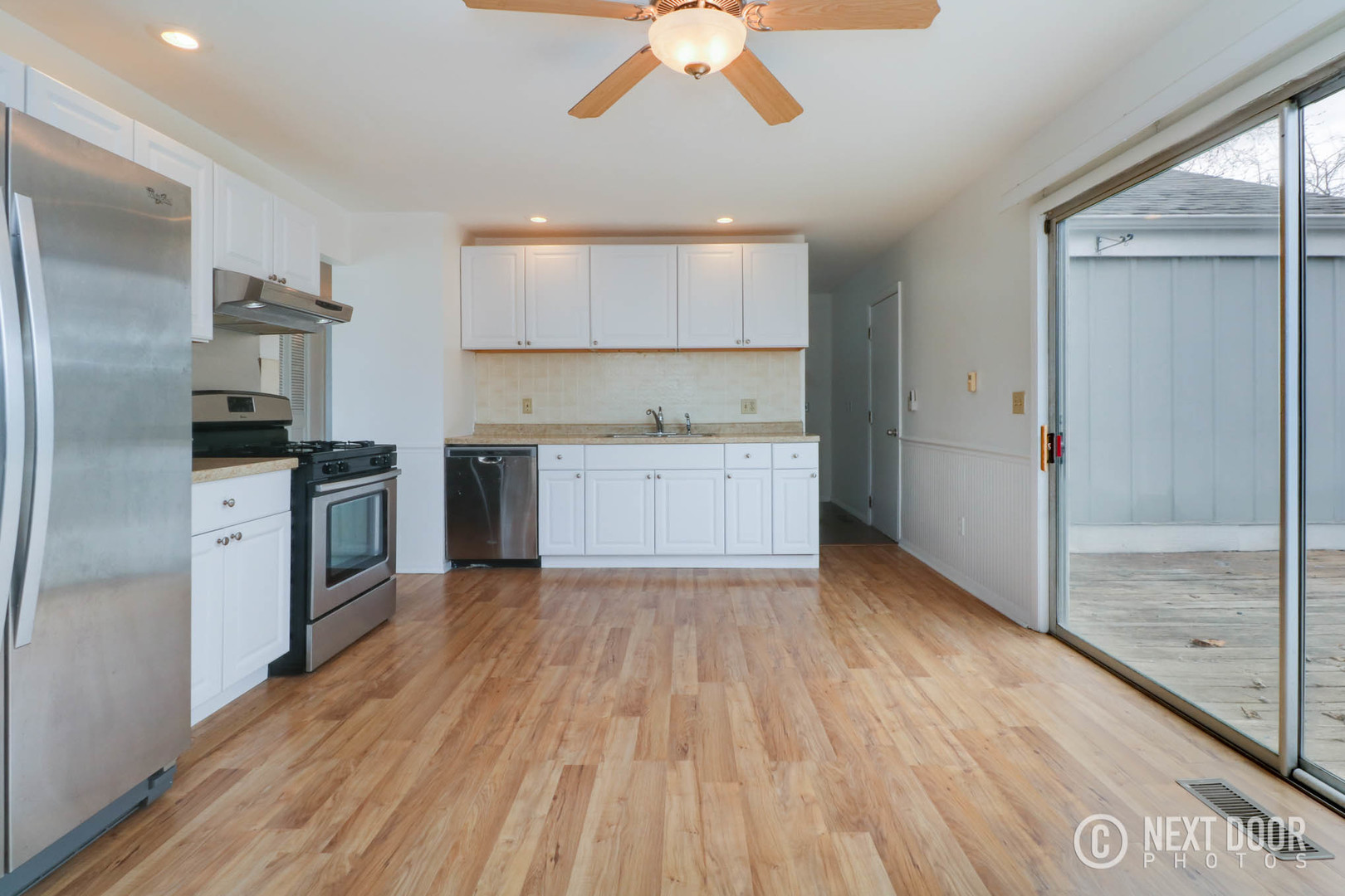 159 Heathgate Road Montgomery, IL 60538 - Photo 4 of 21 a large kitchen with a wooden floor and stainless steel appliances