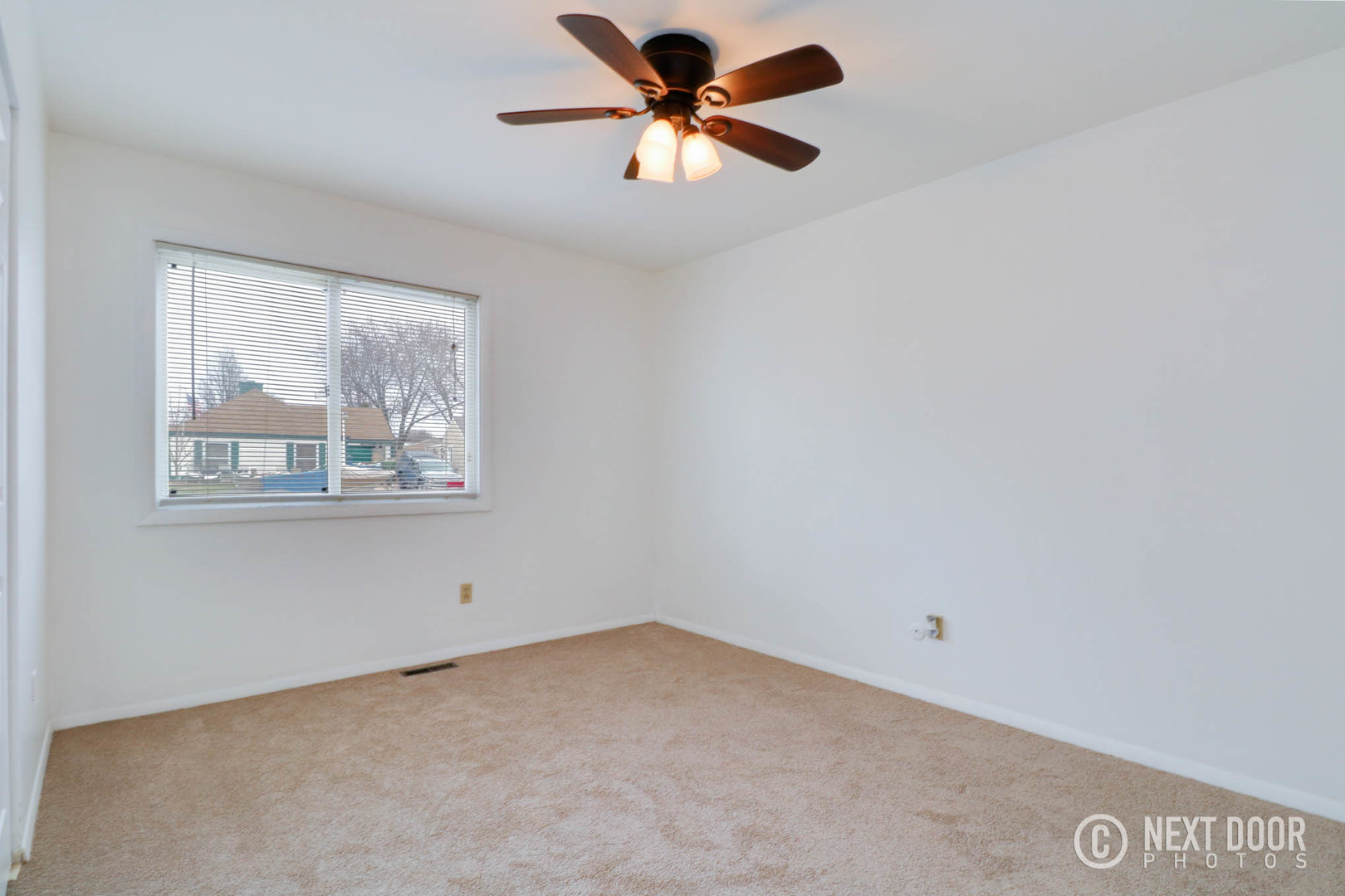 159 Heathgate Road Montgomery, IL 60538 - Photo 10 of 21 an empty room with a window and a fan