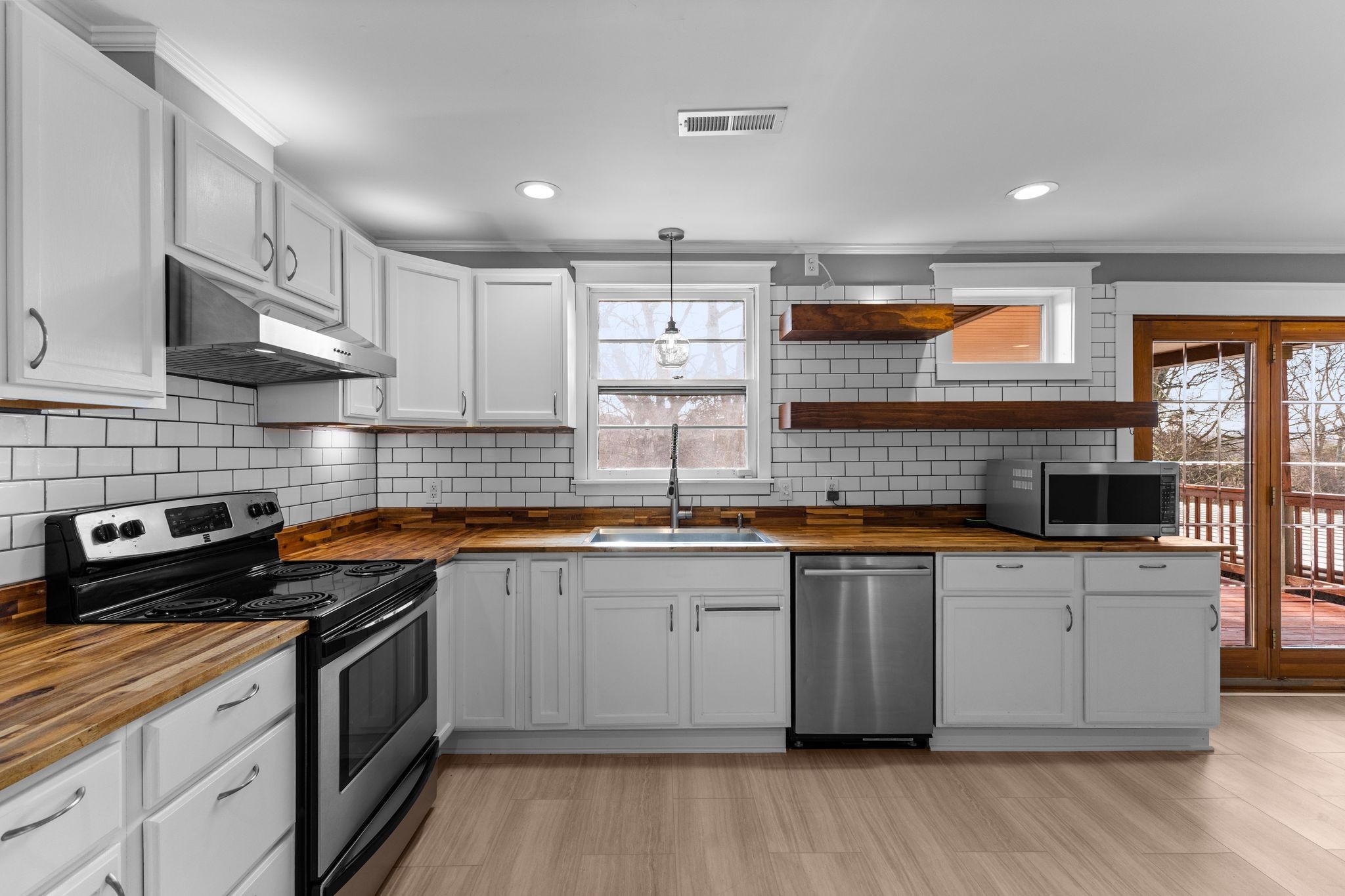 6411 Ranchero Drive Nashville, TN 37209 - Photo 9 of 34 a kitchen with stainless steel appliances a sink stove and cabinets
