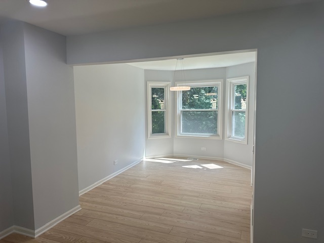 1311 Blue Ridge Parkway Algonquin, IL 60102 - Photo 4 of 21 a view of an empty room with wooden floor and a window