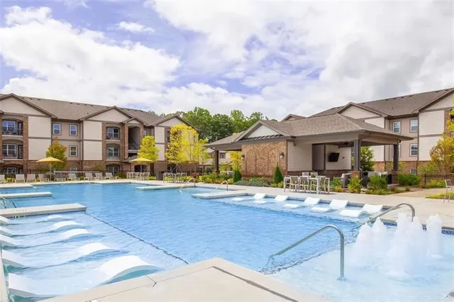 a view of a house with pool and chairs