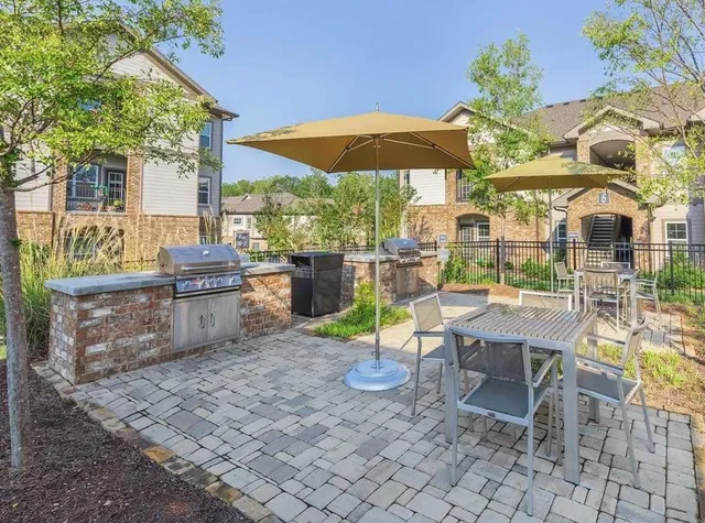 a view of a patio with chairs and potted plants