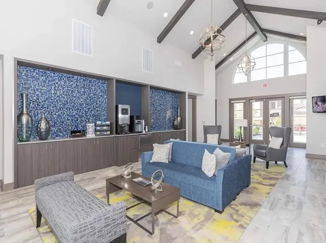 a living room with furniture and a large window