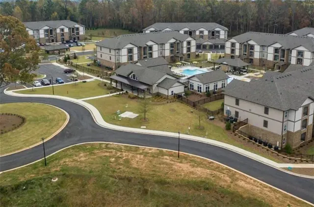 an aerial view of a house with swimming pool and lake view