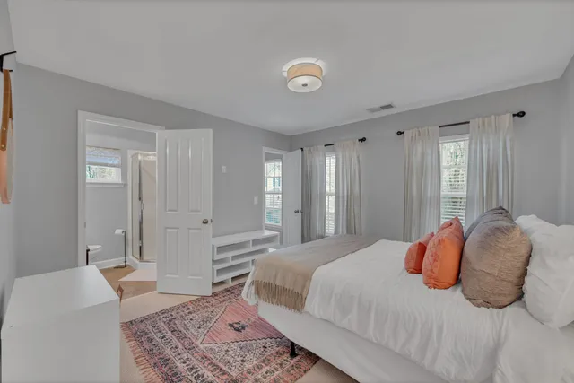 a bedroom with a large bed and a chandelier