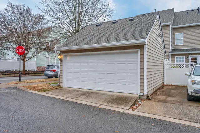 a view of a house with a yard and garage