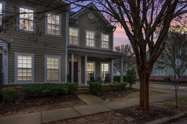 a view of a house with a tree in front