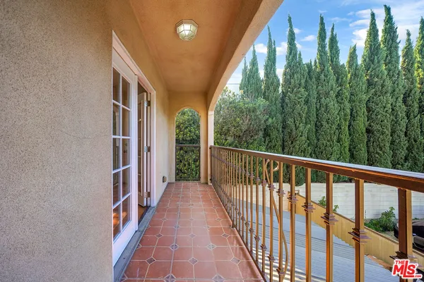 a view of a balcony with wooden floor