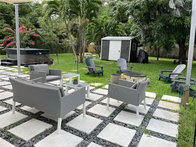 a view of backyard with a patio