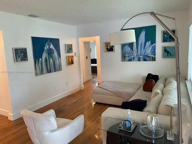 a living room with furniture and kitchen view
