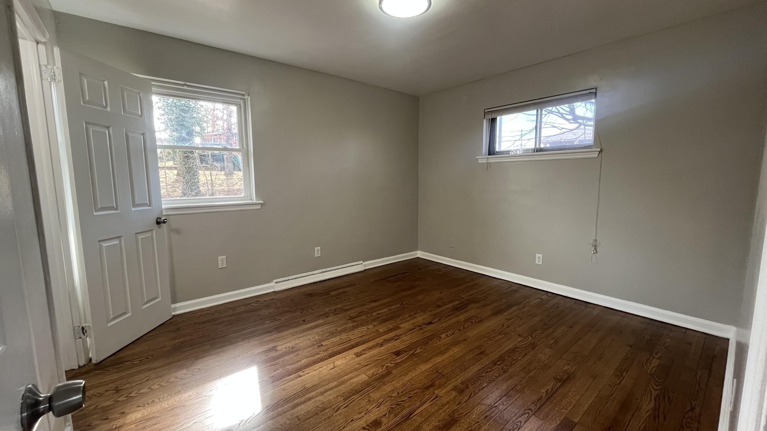 3652 Troutland Avenue Northwest Roanoke, VA 24017 - Photo 9 of 12 a view of an empty room with wooden floor and a window