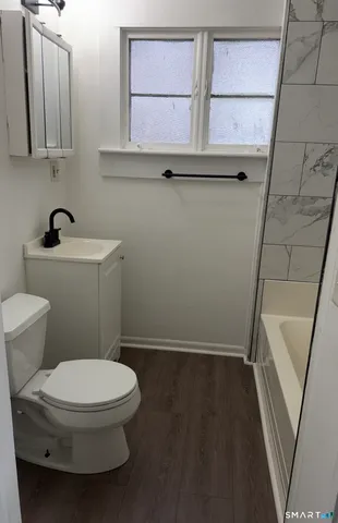 a bathroom with a toilet and a sink