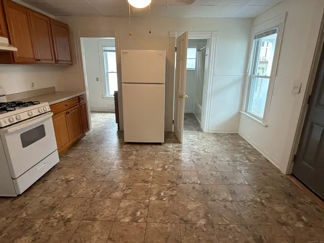 a kitchen with refrigerator a stove a microwave and cabinets