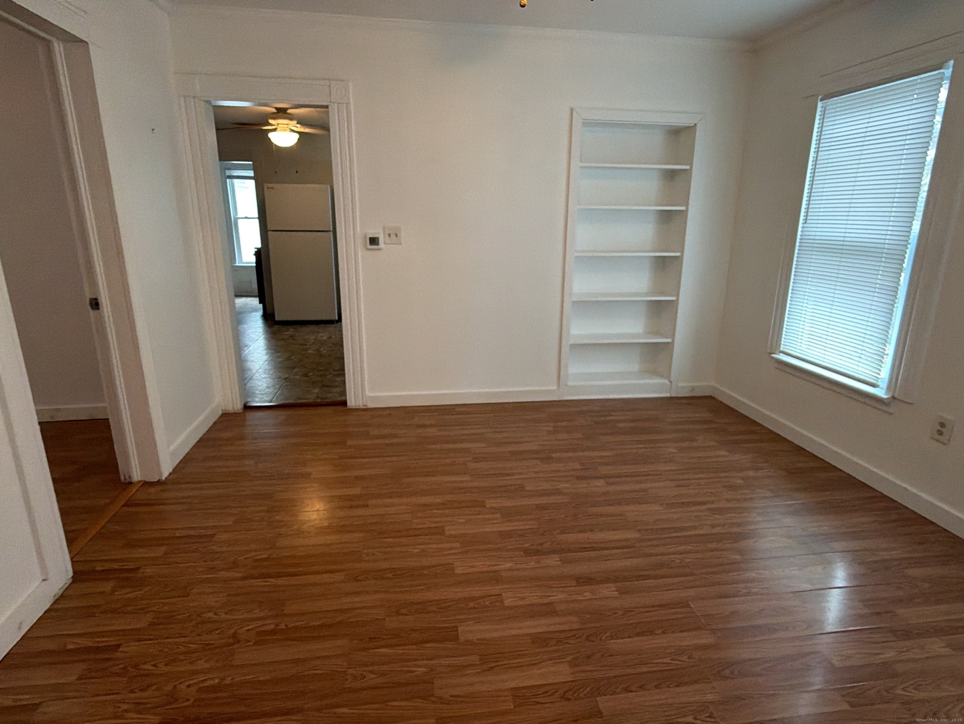 184 Hoffman Street Torrington, CT 06790 - Photo 4 of 12 an empty room with wooden floor and windows