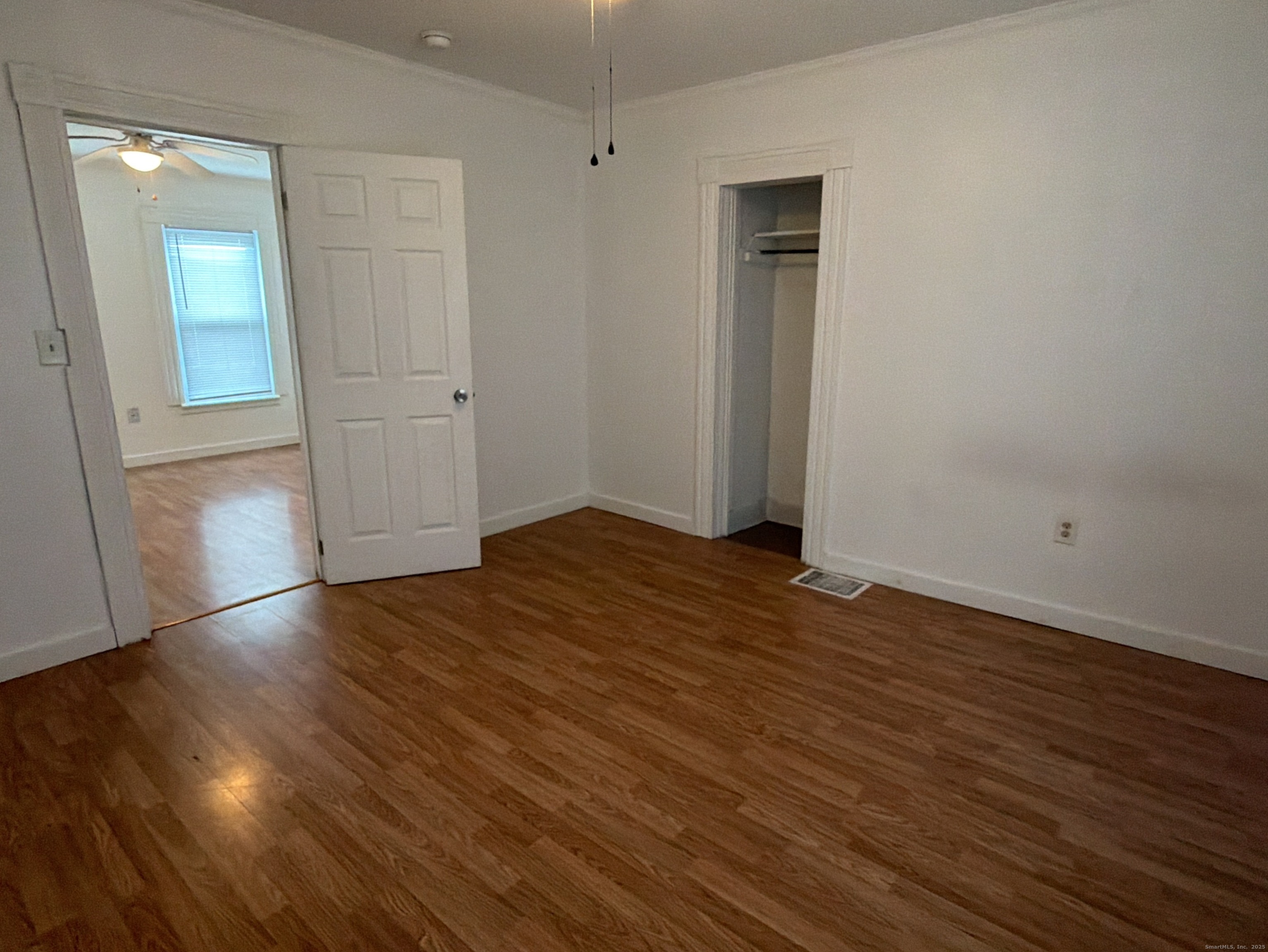 184 Hoffman Street Torrington, CT 06790 - Photo 5 of 12 an empty room with wooden floor and closet