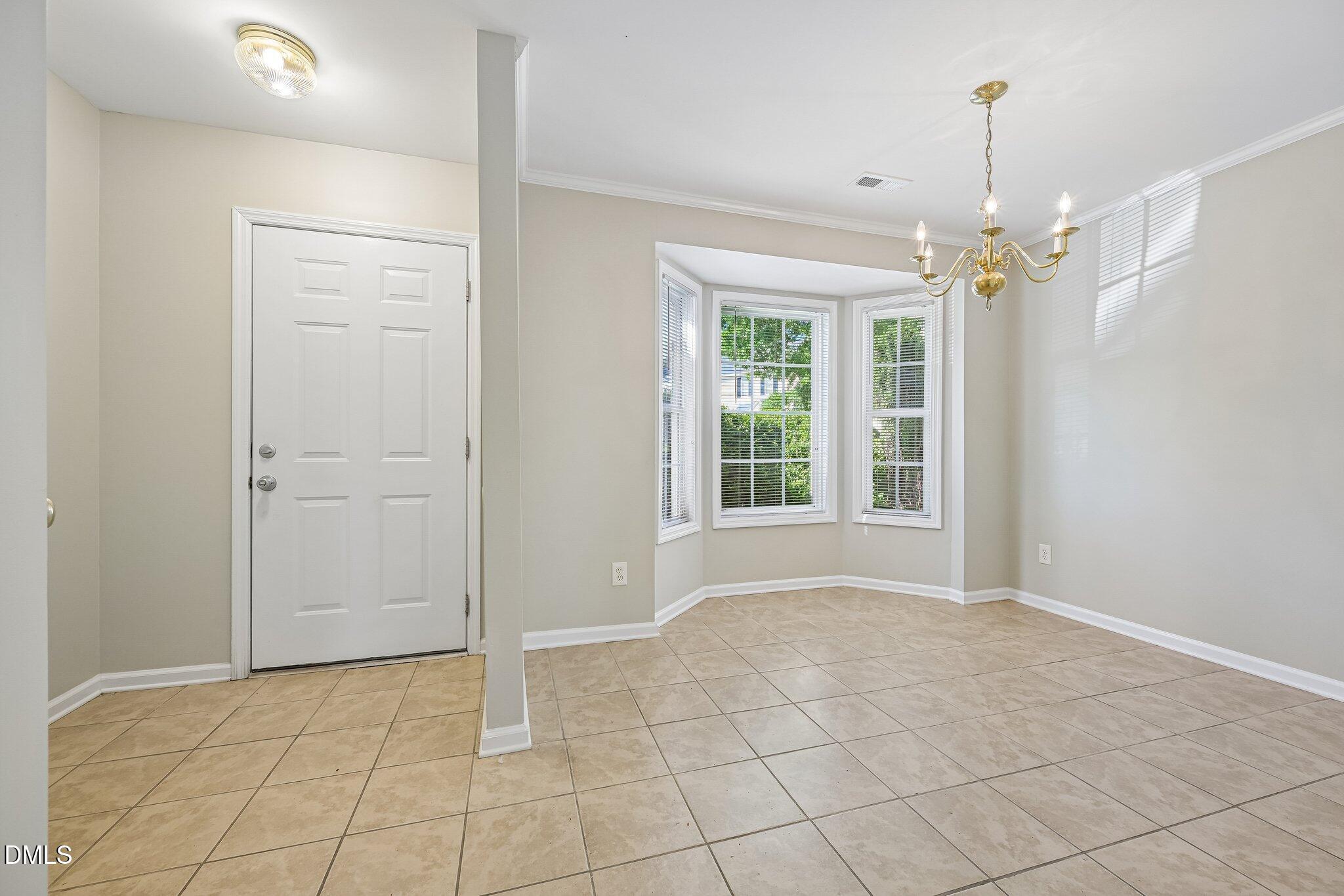 278 South Raleigh Street Angier, NC 27501 - Photo 7 of 35 en empty room with windows and chandelier