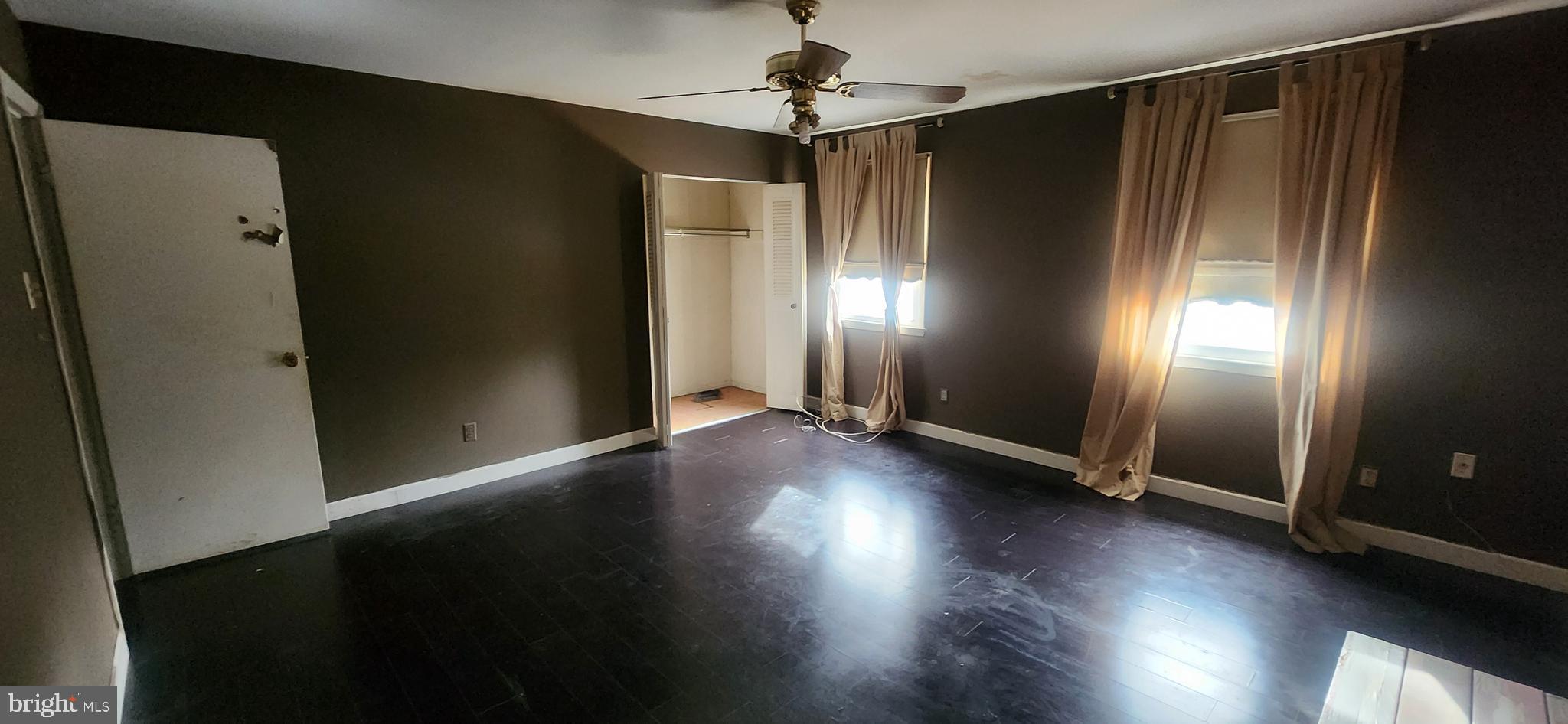 3612 Rockberry Road Baltimore, MD 21234 - Photo 13 of 22 an empty room with wooden floor chandelier fan and windows