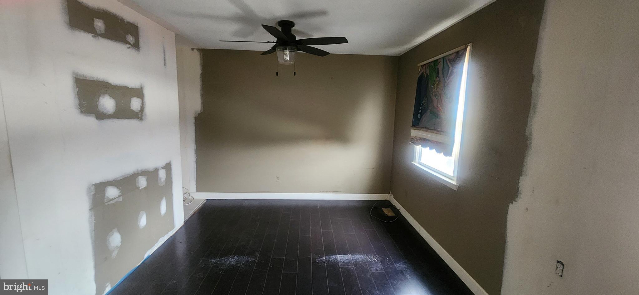 3612 Rockberry Road Baltimore, MD 21234 - Photo 18 of 22 a view of empty room with wooden floor and fan