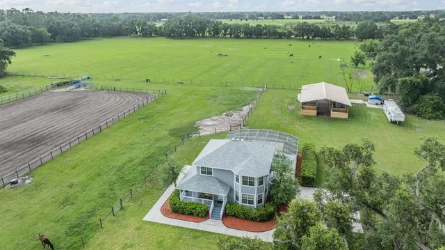 an aerial view of a house with outdoor space lake view and a mountain view