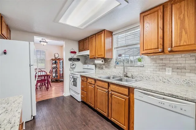 a kitchen with a sink a stove and cabinets