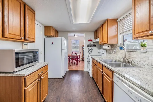 a kitchen with stainless steel appliances granite countertop a stove and a sink
