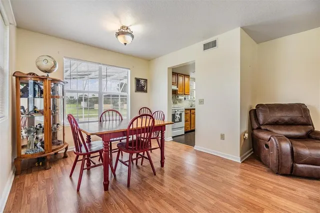 a view of a dining room with furniture and wooden floor