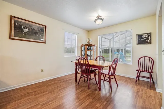 a dining room with furniture and wooden floor