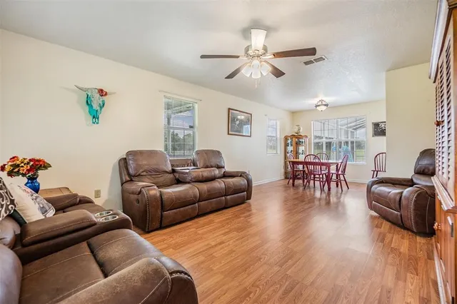 a view of a dining room with furniture and wooden floor