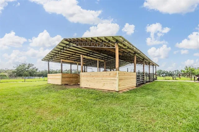 an aerial view of green landscape with trees houses and mountain view