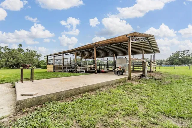 a view of a backyard with wooden fence