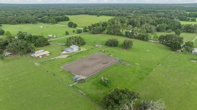 an aerial view of a house with a garden and trees