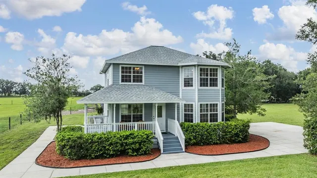 a view of a workspace with furniture and windows