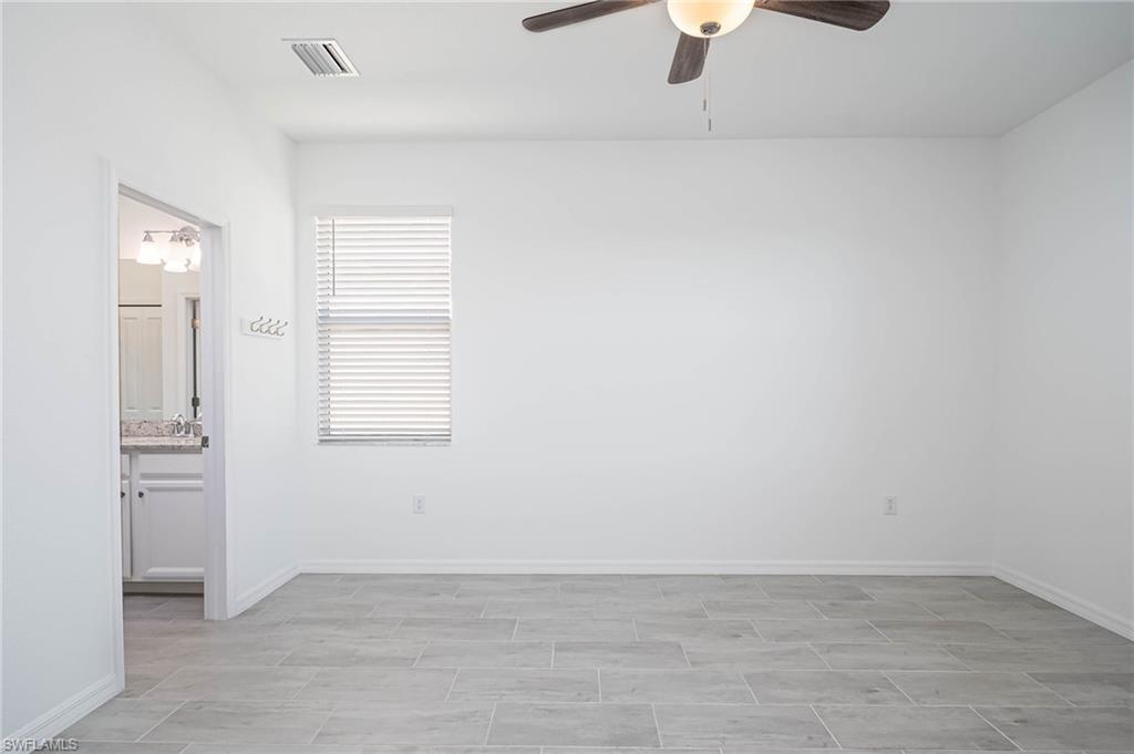 2418 Orchard Street Naples, FL 34120 - Photo 13 of 35 Unfurnished room with ceiling fan