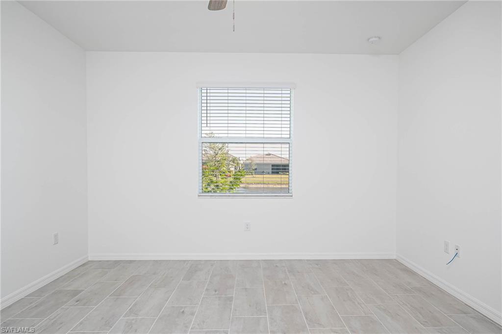 2418 Orchard Street Naples, FL 34120 - Photo 14 of 35 Empty room with ceiling fan and light wood-type flooring