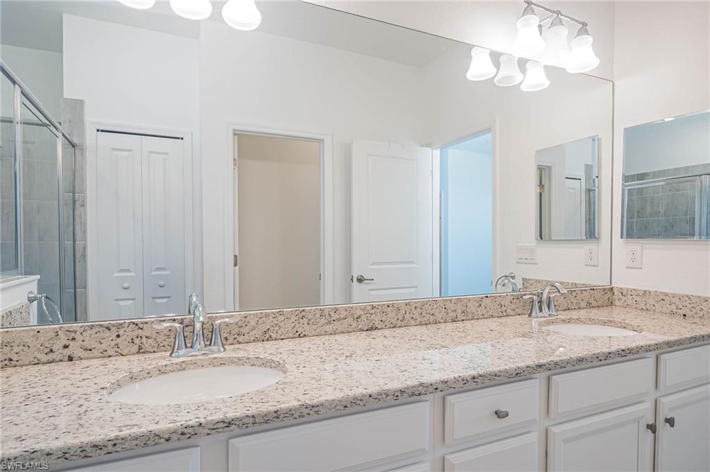 2418 Orchard Street Naples, FL 34120 - Photo 17 of 35 Bathroom featuring vanity and an enclosed shower