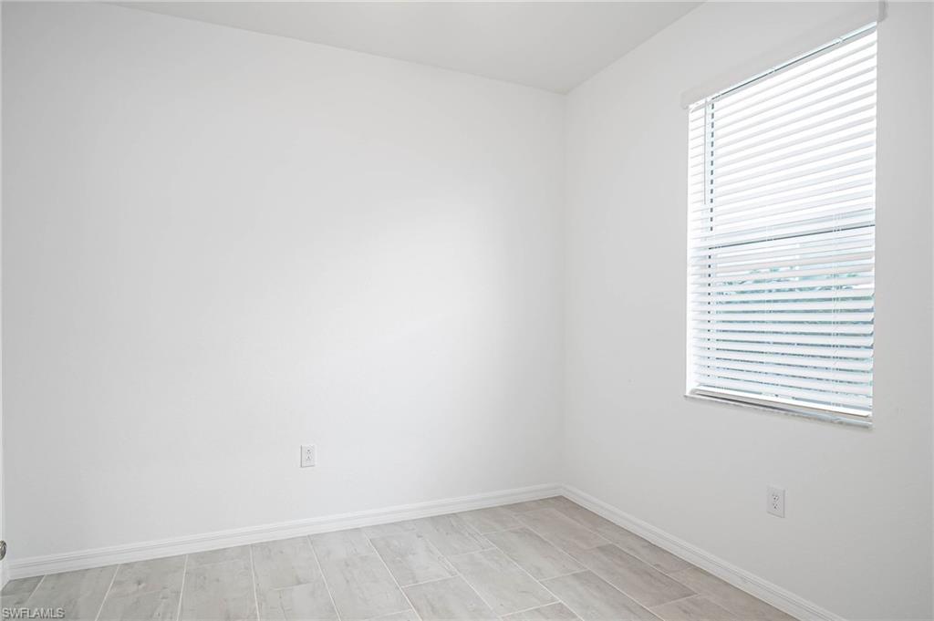 2418 Orchard Street Naples, FL 34120 - Photo 24 of 35 Empty room featuring light hardwood / wood-style flooring