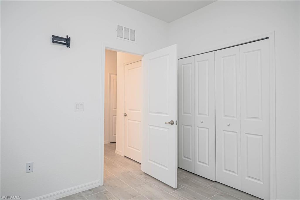 2418 Orchard Street Naples, FL 34120 - Photo 25 of 35 Unfurnished bedroom with a closet