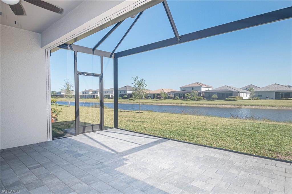 2418 Orchard Street Naples, FL 34120 - Photo 27 of 35 Unfurnished sunroom featuring ceiling fan and a water view