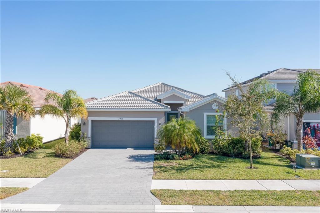 2418 Orchard Street Naples, FL 34120 - Photo 3 of 35 Mediterranean / spanish home featuring a garage and a front lawn