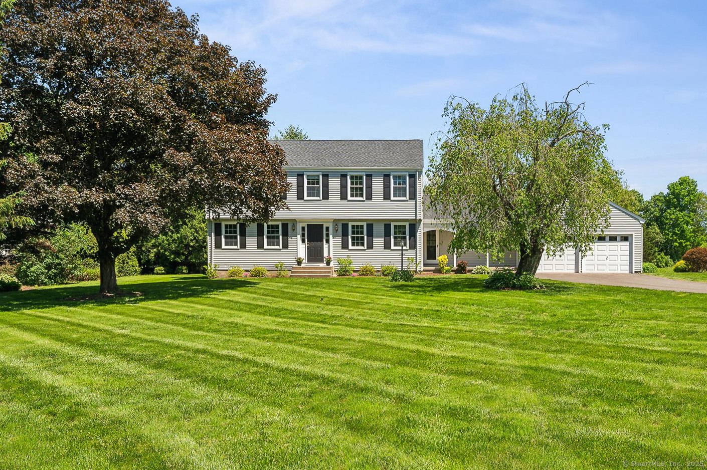 a front view of a house with a garden