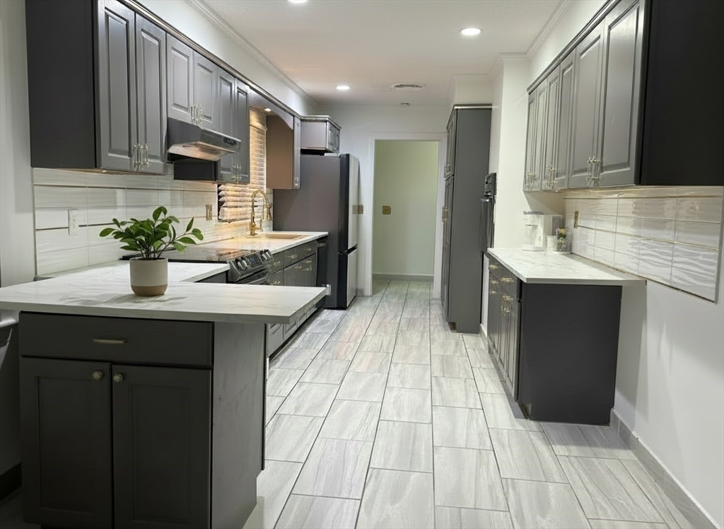 15 Pine Acre Road Springfield, MA 01129 - Photo 4 of 28 a kitchen with stainless steel appliances granite countertop a sink wooden cabinets and a granite counter tops