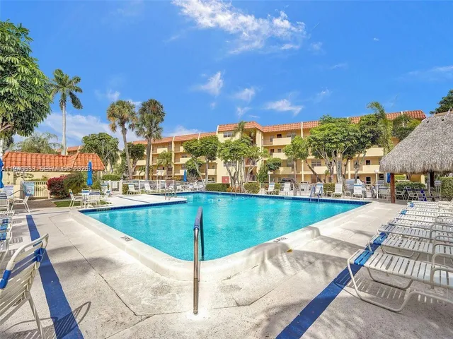 a view of a swimming pool with an outdoor seating