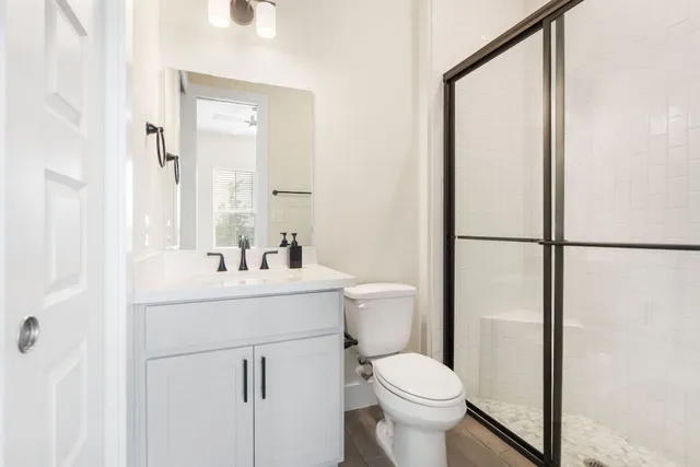 a bathroom with a sink toilet and a mirror