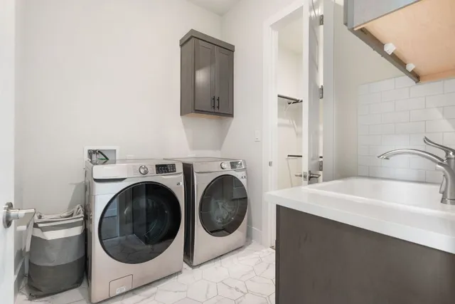 a bathroom with a sink a washer and dryer